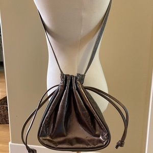 Bronze metallic drawstring bag with multicolour detail.
